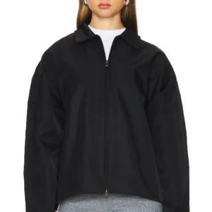 Fear of God Essentials State jacket model wearing oversized fit Fear of God Essentials black jacket front view with zip closure